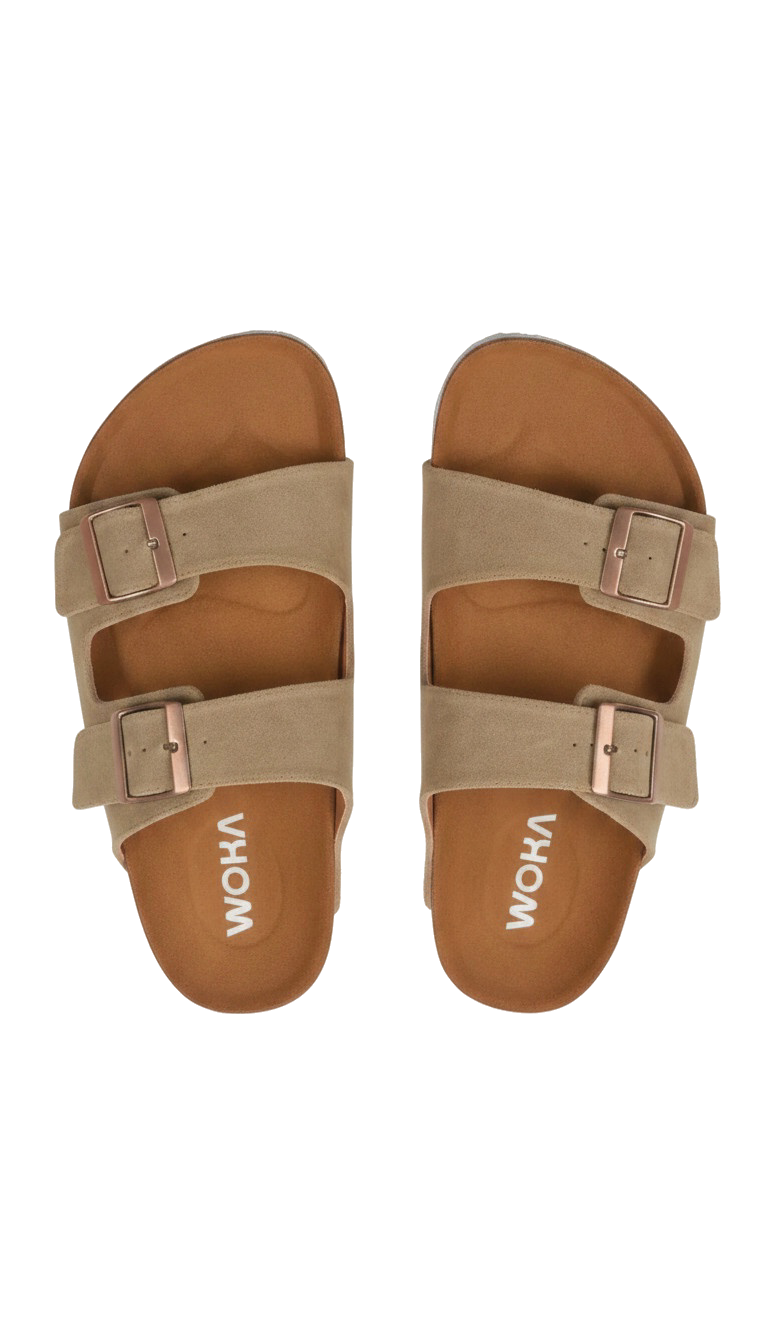 Pair of beige sandals with rose gold buckles on a white background